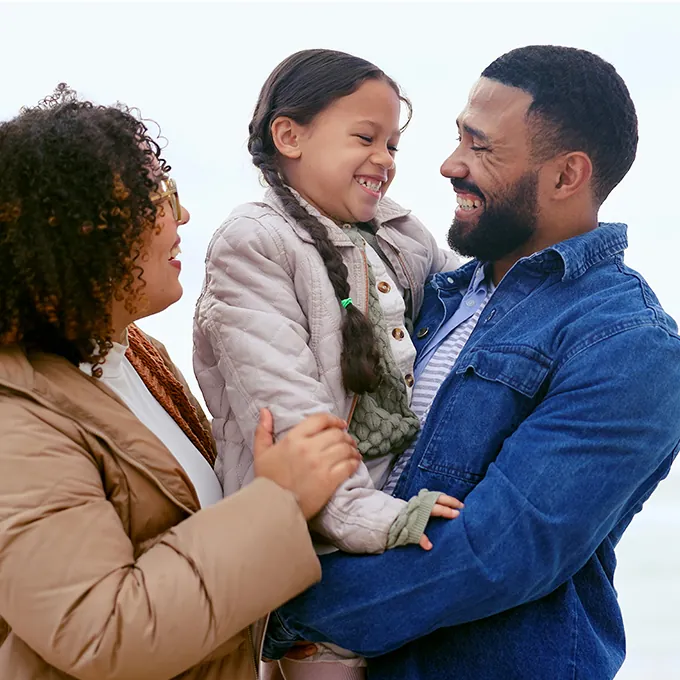 smiling man holding daughter