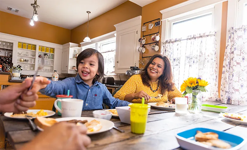 Kids smiling at the kitchen table