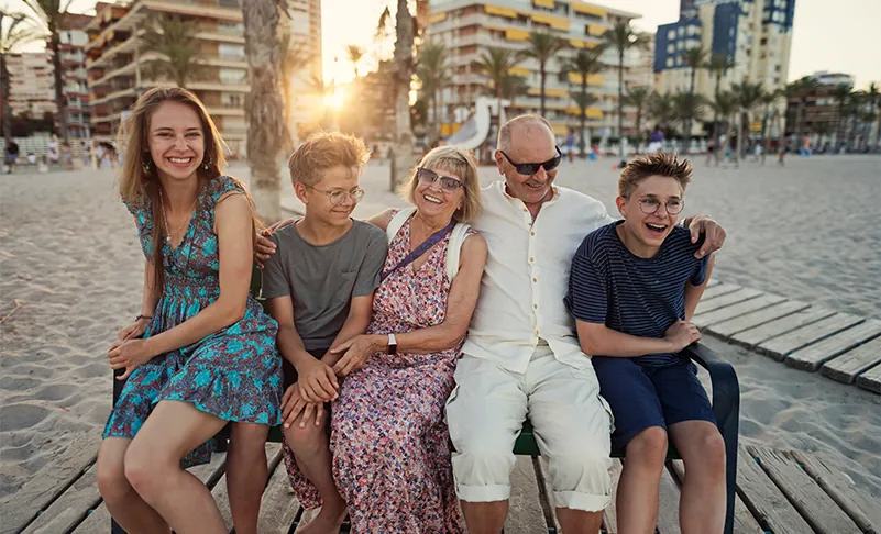 family posing on a beach